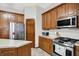 Kitchen with wood cabinets, stainless steel appliances, and an island at 7310 Monaghan Ln, Indianapolis, IN 46217