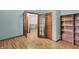 Office space with hardwood floors, bookshelf, and double doors at 7310 Monaghan Ln, Indianapolis, IN 46217