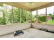 Enclosed patio overlooking a lush backyard, featuring a ceiling fan and ample space at 7310 Monaghan Ln, Indianapolis, IN 46217