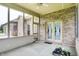 A screened porch with a ceiling fan and exterior brick walls at 7310 Monaghan Ln, Indianapolis, IN 46217