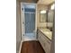 Clean bathroom with granite countertop vanity, updated fixtures, and glass-enclosed shower at 7601 Newport Bay Dr # 203, Indianapolis, IN 46240
