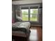 Bedroom with a view showing hardwood flooring and a hammock chair overlooking the lawn at 7601 Newport Bay Dr # 203, Indianapolis, IN 46240