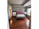 Cozy bedroom features modern decor, wood floors, and a hanging hammock chair by the window at 7601 Newport Bay Dr # 203, Indianapolis, IN 46240