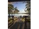 Dock view with lake, a dock, and boats under a clear sky, framed by trees at 7601 Newport Bay Dr # 203, Indianapolis, IN 46240