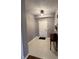 Inviting entryway featuring neutral paint, a modern light fixture, and a classic side table at 7601 Newport Bay Dr # 203, Indianapolis, IN 46240