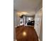 Open-concept living room with fireplace, dark blue sectional, hardwood floors, and sliding barn doors at 7601 Newport Bay Dr # 203, Indianapolis, IN 46240