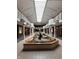 Bright lobby featuring a central water feature, skylights, and second-story balconies at 7601 Newport Bay Dr # 203, Indianapolis, IN 46240
