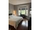 Cozy bedroom with a large window, hardwood floors, and neutral decor at 7601 Newport Bay Dr # 203, Indianapolis, IN 46240