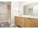 Modern bathroom featuring a double sink vanity, quartz countertop and a shower with glass door at 7650 Micawber Ct, Indianapolis, IN 46256