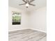 Bedroom with a ceiling fan and light gray laminate flooring at 7650 Micawber Ct, Indianapolis, IN 46256