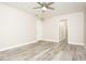 Spacious bedroom with light gray flooring, ceiling fan, and neutral paint palette at 7650 Micawber Ct, Indianapolis, IN 46256