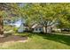 Suburban home with a lush green lawn, mature trees, and clean, neutral siding at 7650 Micawber Ct, Indianapolis, IN 46256