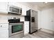 Modern kitchen featuring stainless steel appliances and white cabinetry at 7650 Micawber Ct, Indianapolis, IN 46256