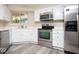 Well-lit kitchen with stainless steel appliances and ample cabinet space at 7650 Micawber Ct, Indianapolis, IN 46256