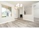 Inviting living area showcasing new gray floors, a fireplace, and tons of natural light at 7650 Micawber Ct, Indianapolis, IN 46256