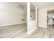 Bright and airy living room with new floors, a ceiling fan, and a view of the backyard at 7650 Micawber Ct, Indianapolis, IN 46256