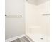 Shower with smooth white surround, chrome showerhead and gold towel bar at 7650 Micawber Ct, Indianapolis, IN 46256