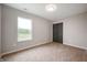 A bright bedroom with neutral walls and carpet has a window and a dark-colored closet at 7918 Wolfgang Pl, Indianapolis, IN 46239