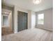 A modern bedroom with neutral walls and carpet features a large closet, window, and plenty of natural light at 7918 Wolfgang Pl, Indianapolis, IN 46239