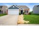 Beautiful brick and siding home with a two-car garage and fresh landscaping at 7918 Wolfgang Pl, Indianapolis, IN 46239