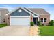Charming single-story brick home with a two-car garage and manicured front lawn at 7918 Wolfgang Pl, Indianapolis, IN 46239