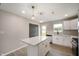 A bright kitchen features a center island, stainless appliances, and backyard views through a sunny window at 7918 Wolfgang Pl, Indianapolis, IN 46239