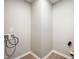 Empty laundry room area featuring utility connections and modern baseboards at 7918 Wolfgang Pl, Indianapolis, IN 46239