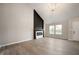 Well-lit living room with a modern fireplace and adjacent entry door at 7918 Wolfgang Pl, Indianapolis, IN 46239