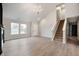 Bright living room with vaulted ceilings, hardwood floors, and staircase to the upper level at 7918 Wolfgang Pl, Indianapolis, IN 46239
