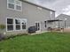 Spacious backyard with a well-manicured lawn, outdoor patio area, and lush landscaping at 8876 Boylan Pl, Pendleton, IN 46064