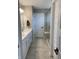 Well-lit bathroom features dual sinks, white cabinets, tiled floors, and a glass door shower at 8876 Boylan Pl, Pendleton, IN 46064