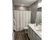Bathroom featuring a double vanity, shower with a white shower curtain, and neutral tones at 8876 Boylan Pl, Pendleton, IN 46064