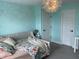 Bedroom featuring unique flower wall art, a modern chandelier, and comfortable bed at 8876 Boylan Pl, Pendleton, IN 46064