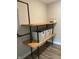 Closet featuring open wooden shelving, industrial pipe fixtures, and gray storage bins at 8876 Boylan Pl, Pendleton, IN 46064