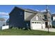 Side view of a beautiful gray home with an attached two-car garage and lush green lawn at 8876 Boylan Pl, Pendleton, IN 46064