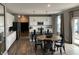 Modern kitchen with white cabinetry, stainless steel appliances, a central island, and a dining area at 8876 Boylan Pl, Pendleton, IN 46064