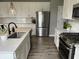 This kitchen features white cabinets, stainless steel appliances, a sink, and a view of the backyard at 8876 Boylan Pl, Pendleton, IN 46064