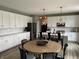 Bright eat-in kitchen features white cabinets, stainless appliances, and a large island with breakfast bar seating at 8876 Boylan Pl, Pendleton, IN 46064