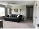 Relaxing living room featuring a large couch, neutral carpet, and natural light from a large window at 8876 Boylan Pl, Pendleton, IN 46064