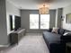 Inviting living room features neutral tones, large TV, plush seating, and natural light from a bright window at 8876 Boylan Pl, Pendleton, IN 46064