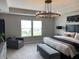 This bedroom is equipped with an elegant chandelier, neutral colors, carpeted floor, and large window at 8876 Boylan Pl, Pendleton, IN 46064