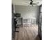 Home office featuring wood floors, black French doors, neutral walls, and a ceiling fan at 8876 Boylan Pl, Pendleton, IN 46064