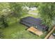 An aerial view displaying the property's backyard deck, landscaping, and neighborhood at 8933 W 1050 S, Fortville, IN 46040