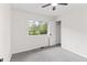 Bright bedroom featuring fresh white walls, grey carpet, and a window offering a lovely outdoor view at 8933 W 1050 S, Fortville, IN 46040