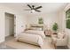Bright bedroom featuring a ceiling fan, neutral tones, carpet, and a convenient closet for ample storage at 8933 W 1050 S, Fortville, IN 46040
