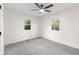 Neutral bedroom with carpet, ceiling fan, and two windows providing natural light at 8933 W 1050 S, Fortville, IN 46040