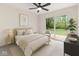 This bright bedroom features a large sliding glass door, wood frame bed, and comfortable neutral tones at 8933 W 1050 S, Fortville, IN 46040
