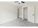 Neutral bedroom featuring carpet, closet, and modern light fixture at 8933 W 1050 S, Fortville, IN 46040