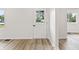 Bright entryway with wood-look flooring and a door with a view to the landscaped front yard at 8933 W 1050 S, Fortville, IN 46040