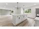 Modern kitchen with white cabinets, stainless steel appliances, a large island, and an open floor plan at 8933 W 1050 S, Fortville, IN 46040